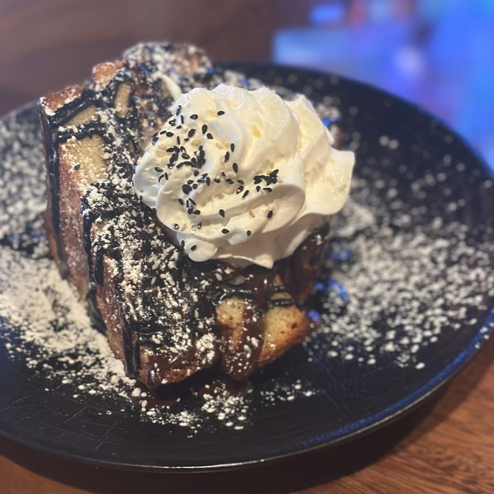 DaVinci & Yu's dessert: French toast with chocolate drizzle, powdered sugar, whipped cream, and sesame seeds.